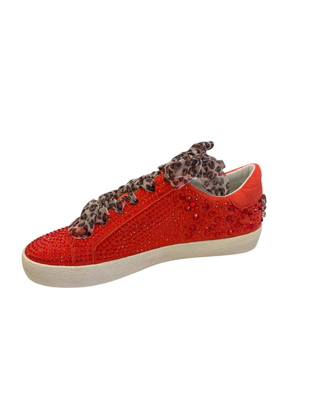 Inner side of red embellished sneaker with clean vegan leather finish and rhinestone embellishments.
