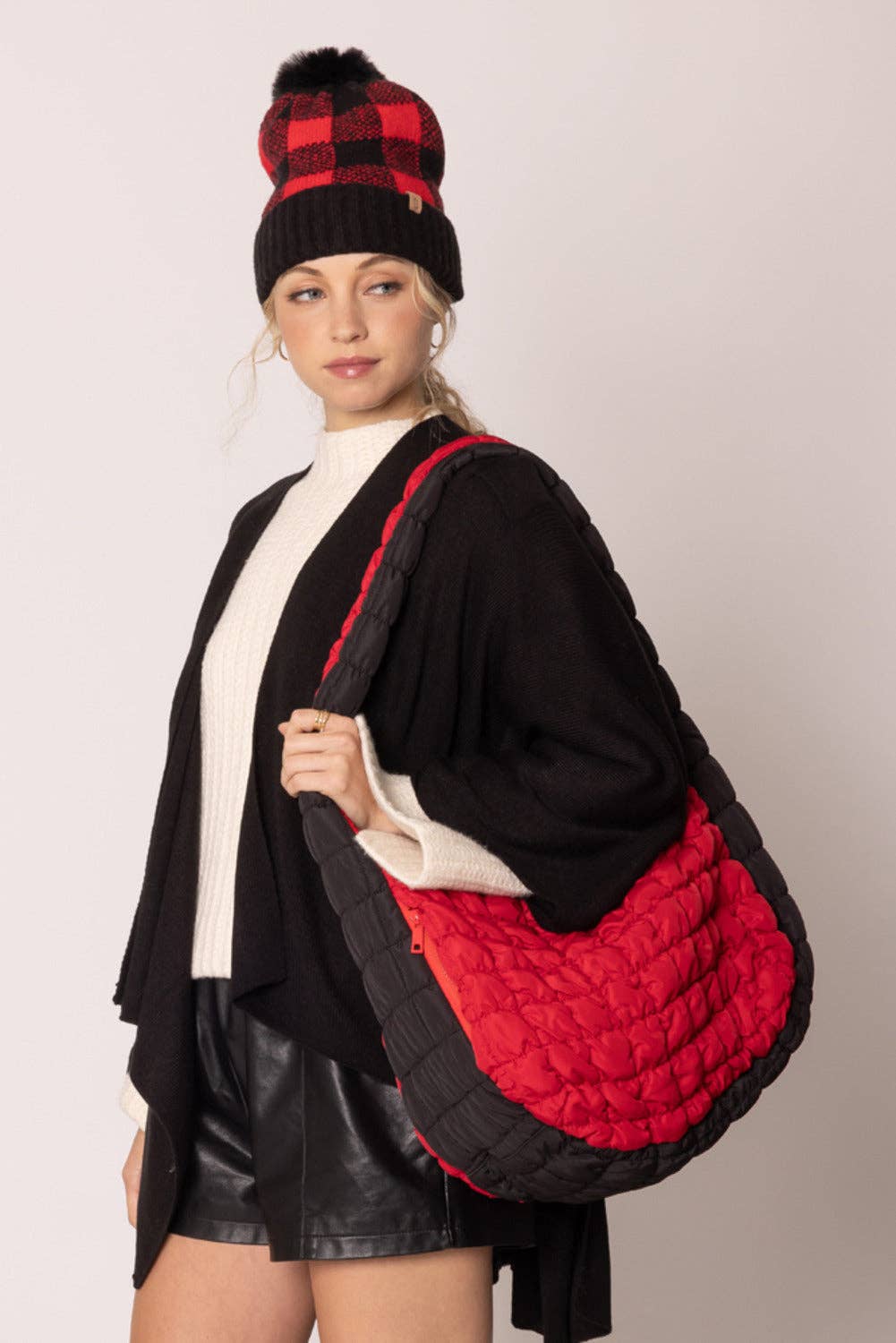 red bag with black sides quilted puffer bag