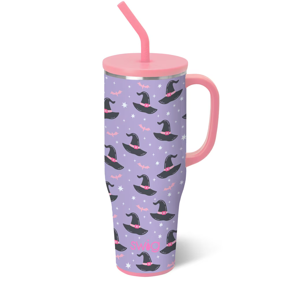 Swig Spellbound Mega Mug 40oz with glitter glow-in-the-dark bats, stars, and whimsical witch hats on a lavender background, comfort-grip handle, and silicone flexi-tip straw.