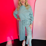 Ash blue wide-leg French terry pants with drawstring waist and exposed seam details.