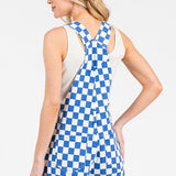Blue checkered sleeveless romper overalls with adjustable straps, cuffed shorts, and multiple pockets, laid flat to show details.