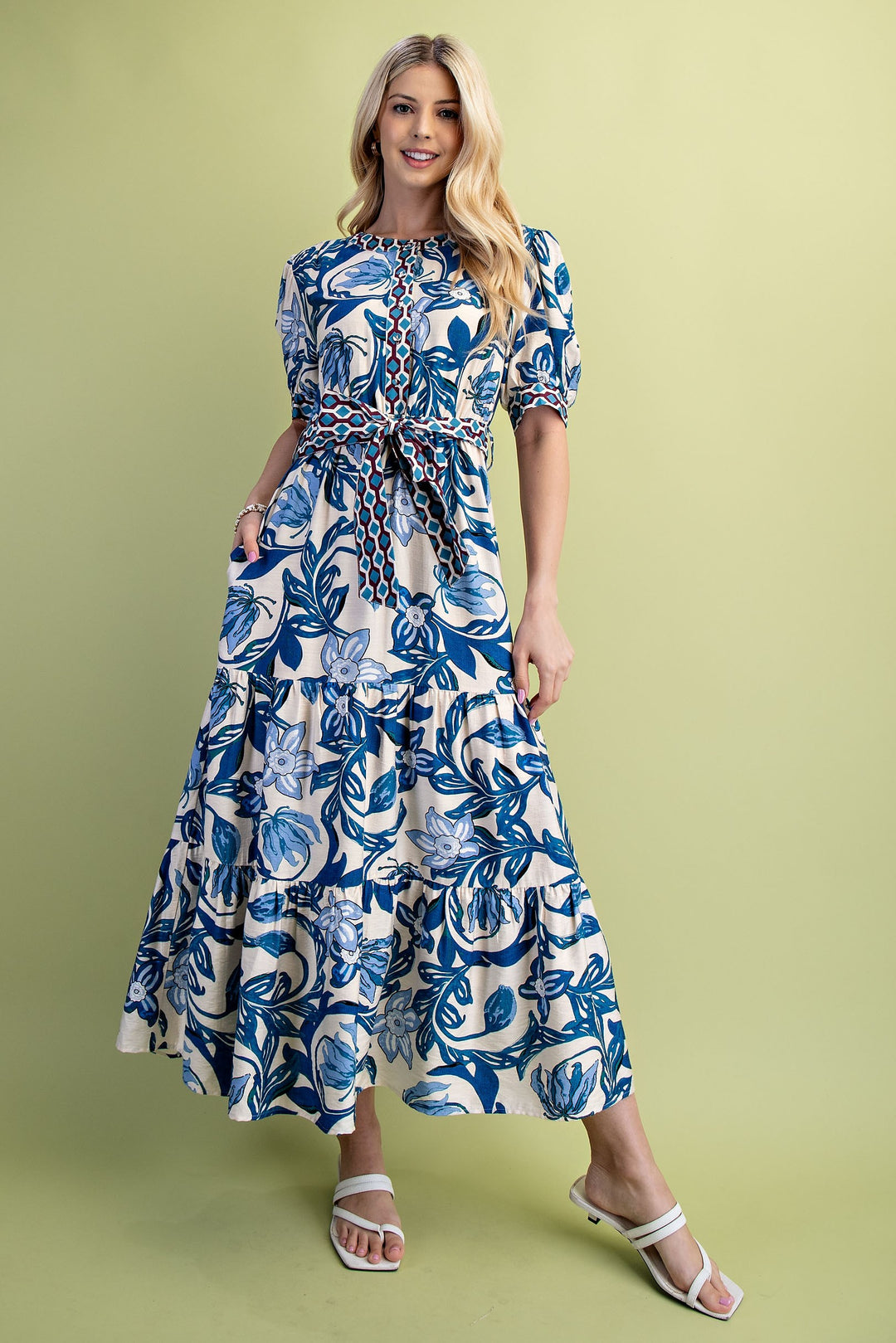 Cobalt blue and white floral print tiered maxi dress with short sleeves and a belted waist.