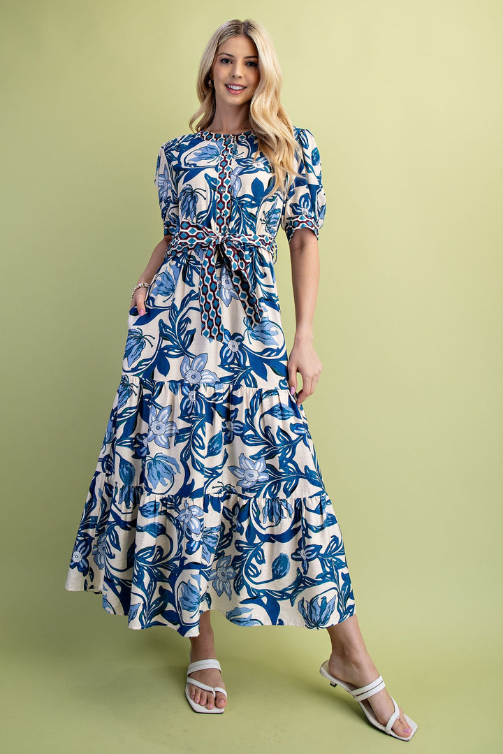 Cobalt blue and white floral print tiered maxi dress with short sleeves and a belted waist.