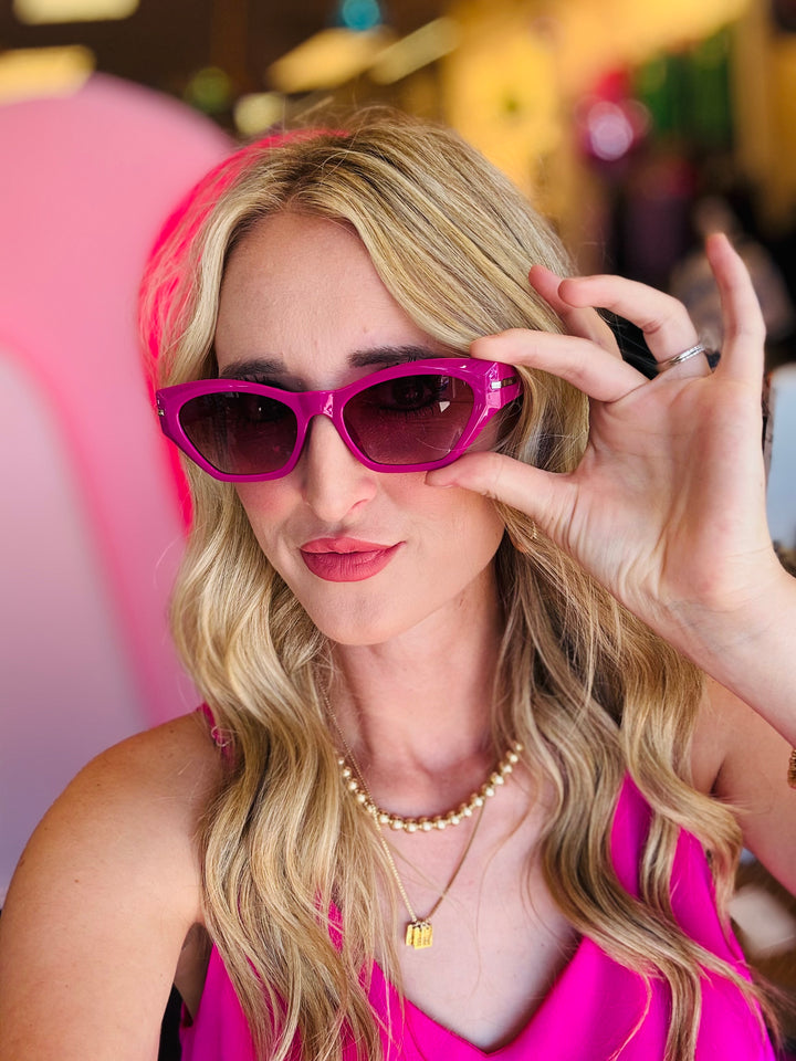 Close-up of the Sawtelle Berry Gradient Sunglasses highlighting the fuchsia-to-black gradient lenses, sharp cat eye edges, and sleek metal detailing.