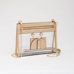 Clear crossbody bag with shimmering gold trim and matching hardware, featuring a detachable sunglasses holder—elegant and event-ready.
