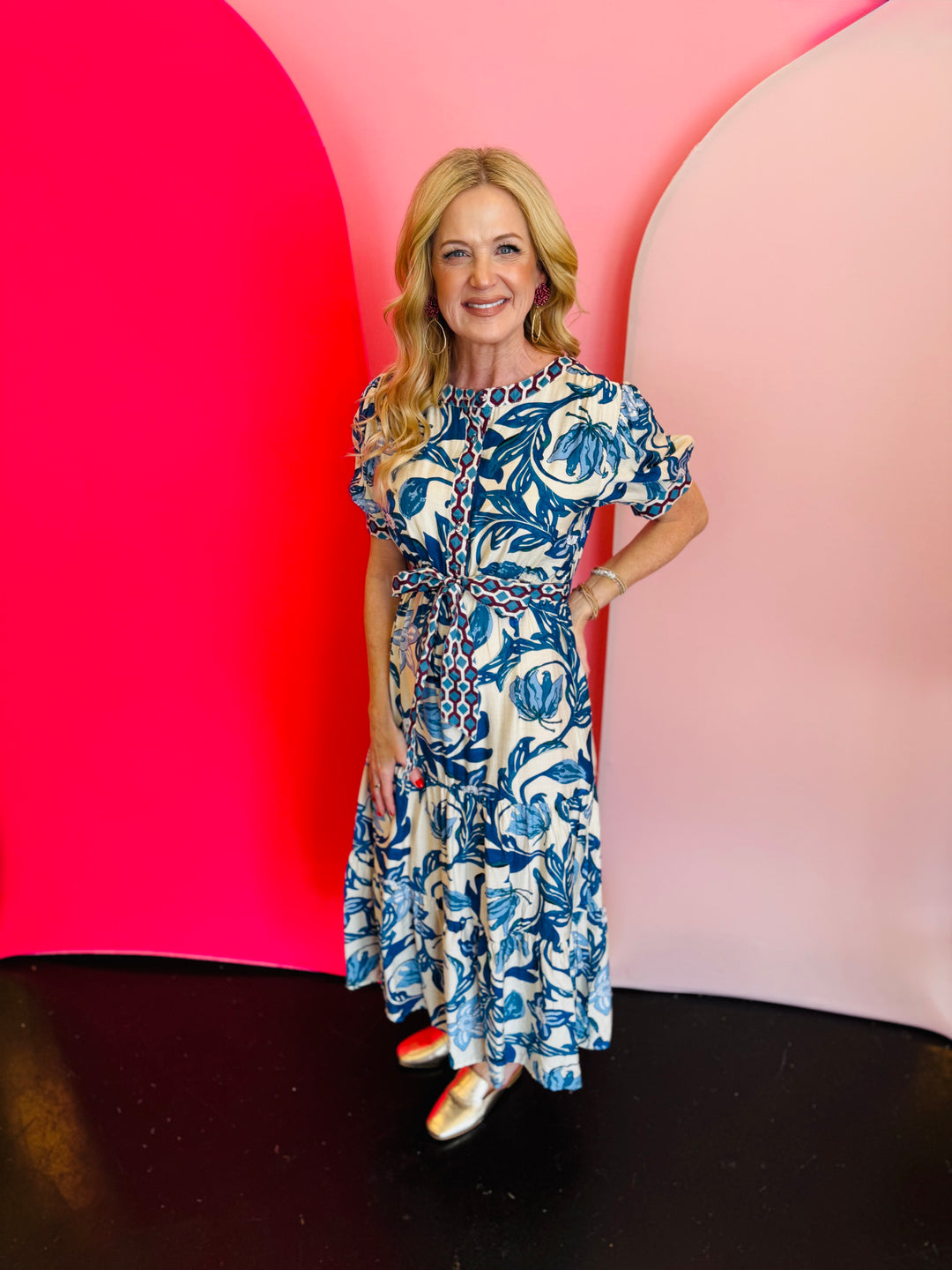 Cobalt blue and white floral print tiered maxi dress with short sleeves and a belted waist.