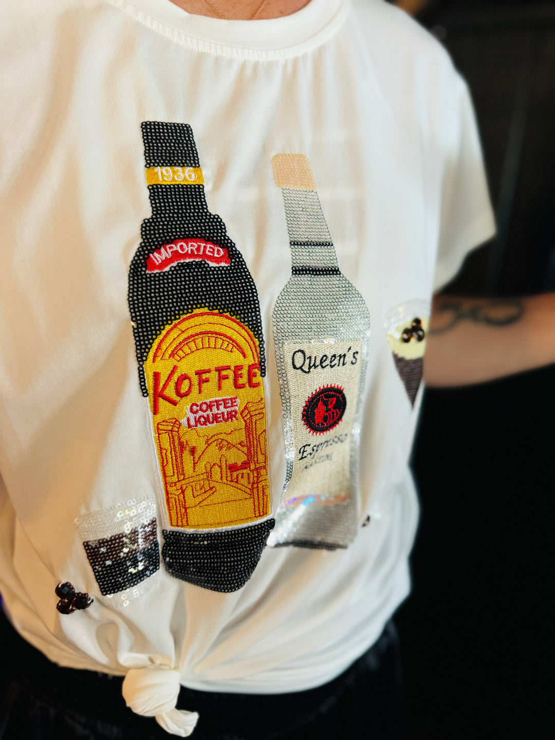 Close up of Queen Of Sparkle Espresso Tee with sequins and rhinestones.