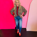 Toffee leopard print blouse with blue and red stripe accents and drop shoulder rib band trim.