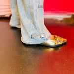 Close-up of the bottom hem of the Jovie jeans showing subtle button detailing.