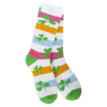 A pair of fuzzy, plush crew socks with a colorful horizontal stripe pattern. Small green shamrocks are scattered across the stripes.