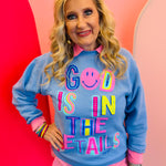 Turquoise sweatshirt with bold multicolor “God is in the Details” lettering and classic crewneck fit.