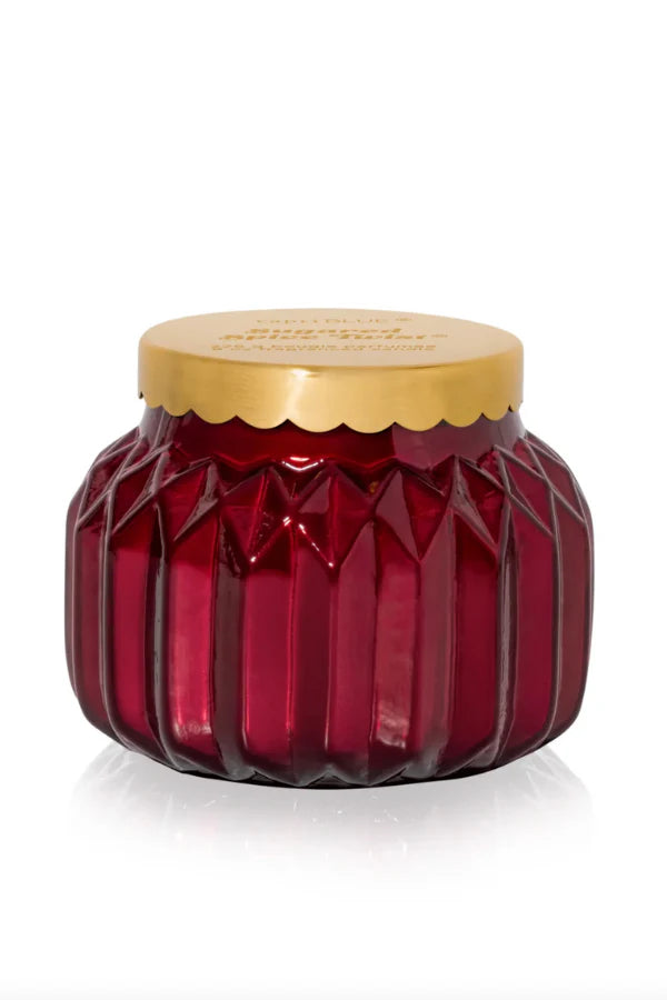 An 8oz Capri Blue Sugared Spice Twist Royal Gem Petite Candle in a decorative jar.