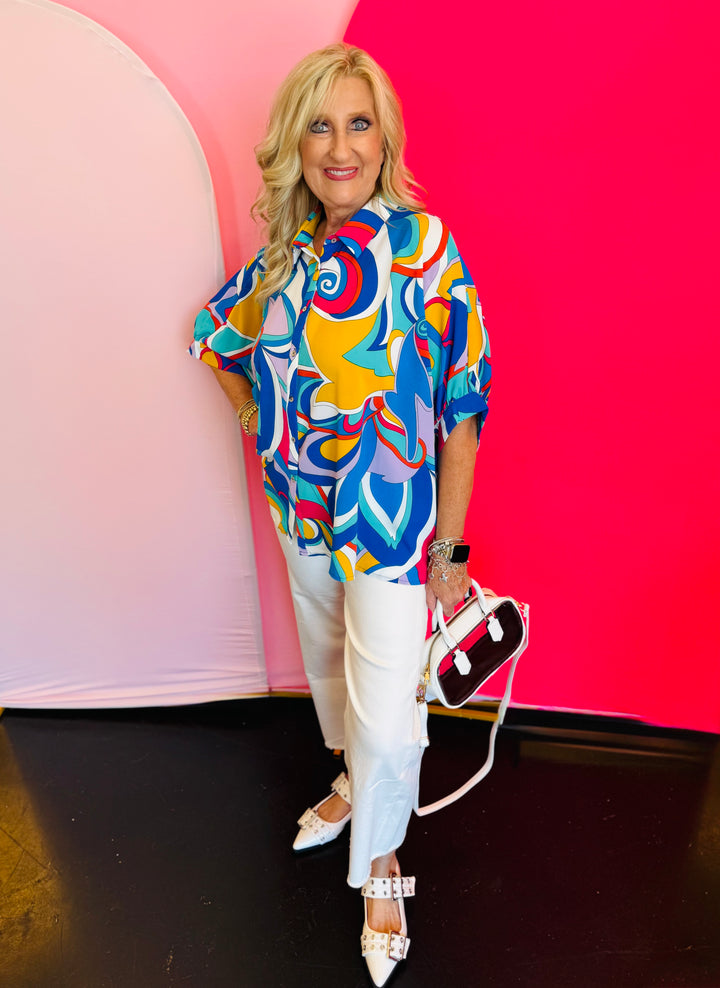 Full-body view of the Blue Printed Blouse styled with white pants and a white handbag, highlighting the blouse’s loose fit and everyday elegance.