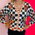 Close up of Queen Of Sparkles checkered University Of Texas  game day sequin cardigan.