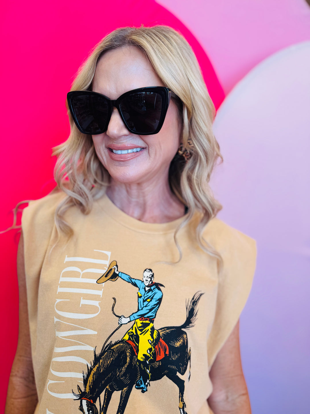Front view of the Hey Cowgirl Cap Sleeve Tee in wheat color featuring bold cowboy-themed graphics for a trendy Western-inspired look