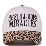 Leopard print cap with “He Still Does Miracles” embroidered on the front.
