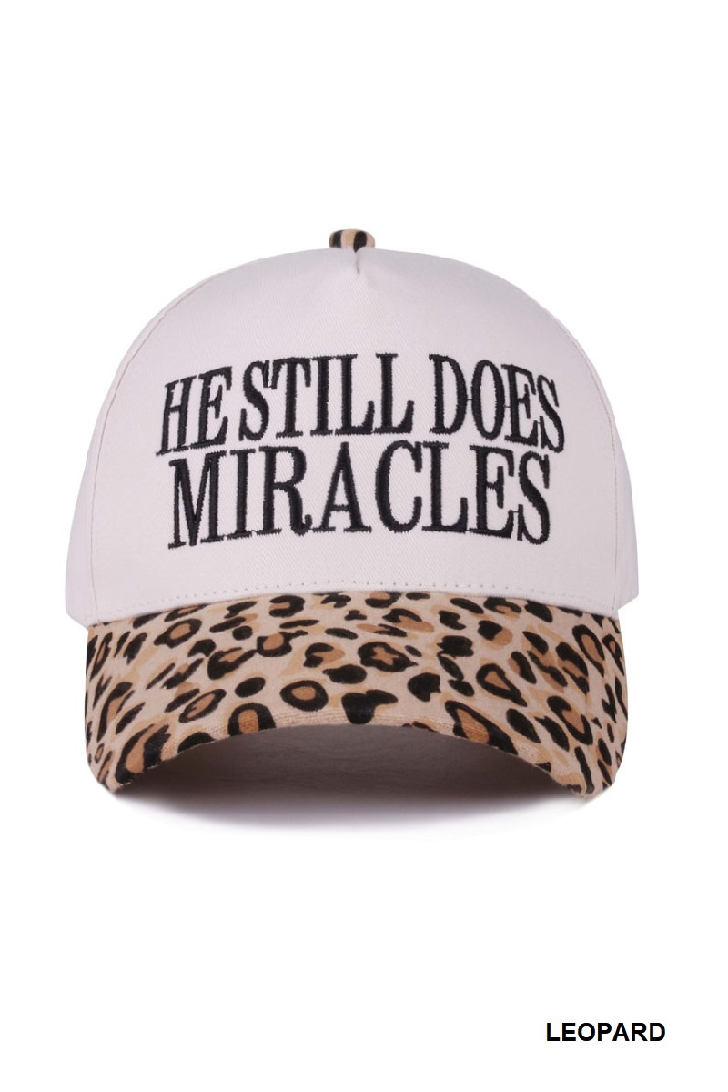 Leopard print cap with “He Still Does Miracles” embroidered on the front.