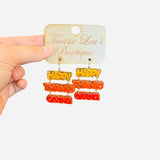 acrylic dangle earrings, happy thanksgiving, orange, red and mustard yellow letters. 