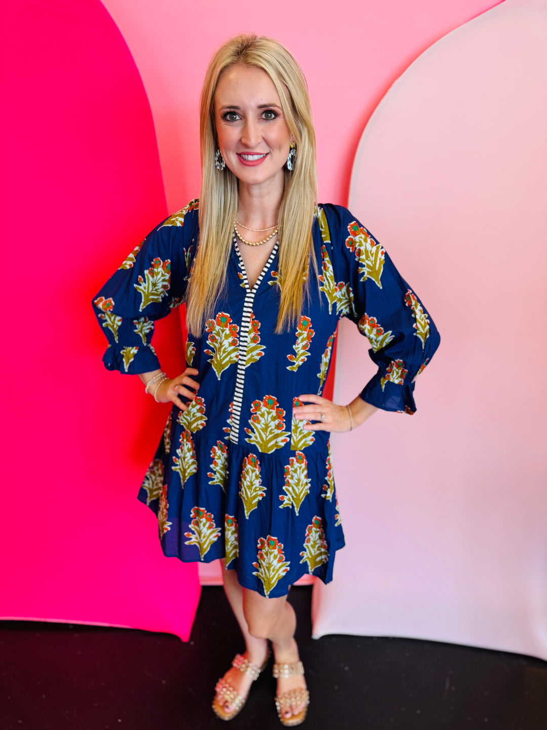 Blue floral dress with navy and white striped front trim and ruffle hemline