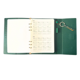 Calendar in green clutch folio journal with calender and matching pen. 'FUCK IT UP' gold foil text.