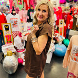 Brown textured jacquard mini dress with quarter zipper neckline, side pockets, and high-low hem.