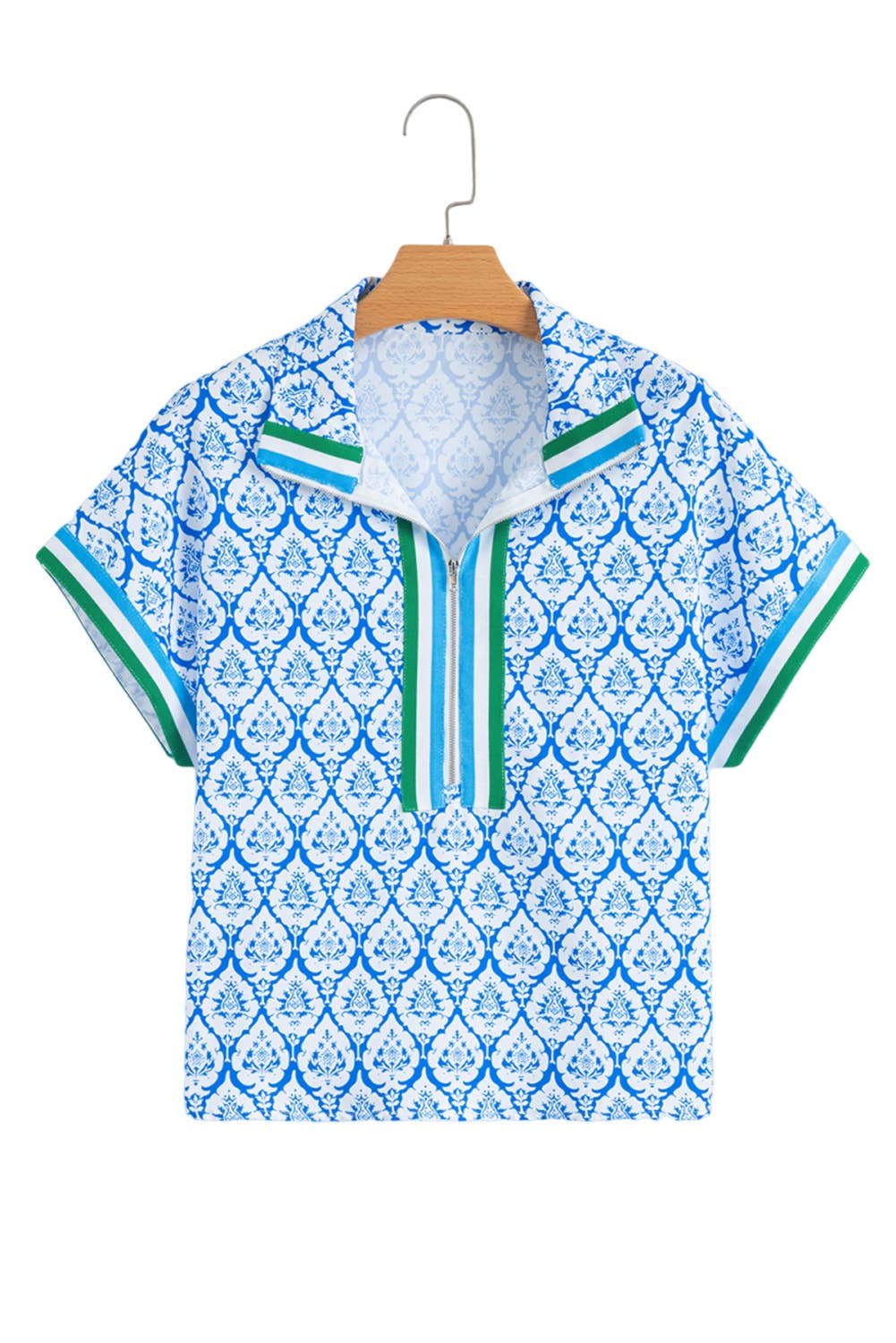 flat lay of blue and white geometric floral half zip top