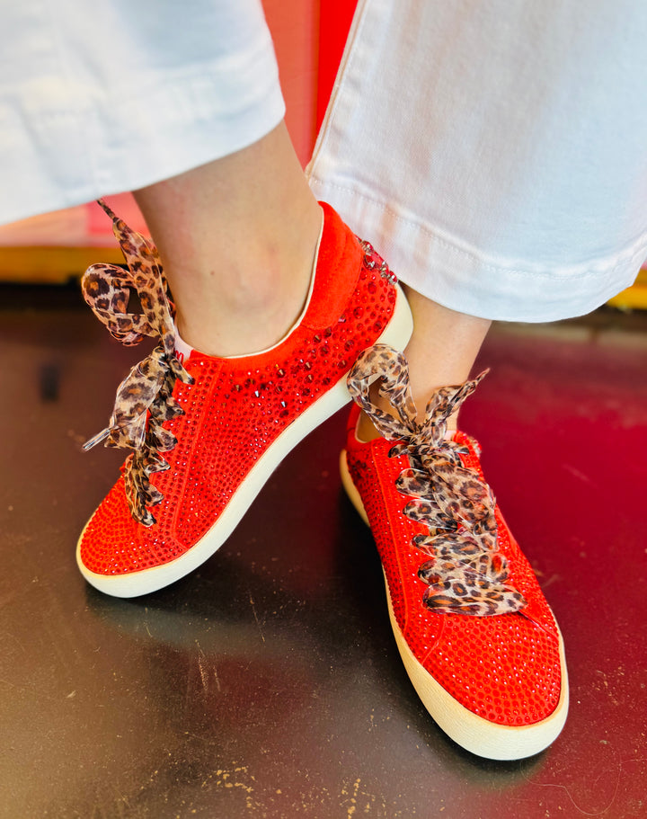 PIcture of red vegan leather sneaker featuring a bold rhinestone star embellishment and slight platform heel with leopard laces.