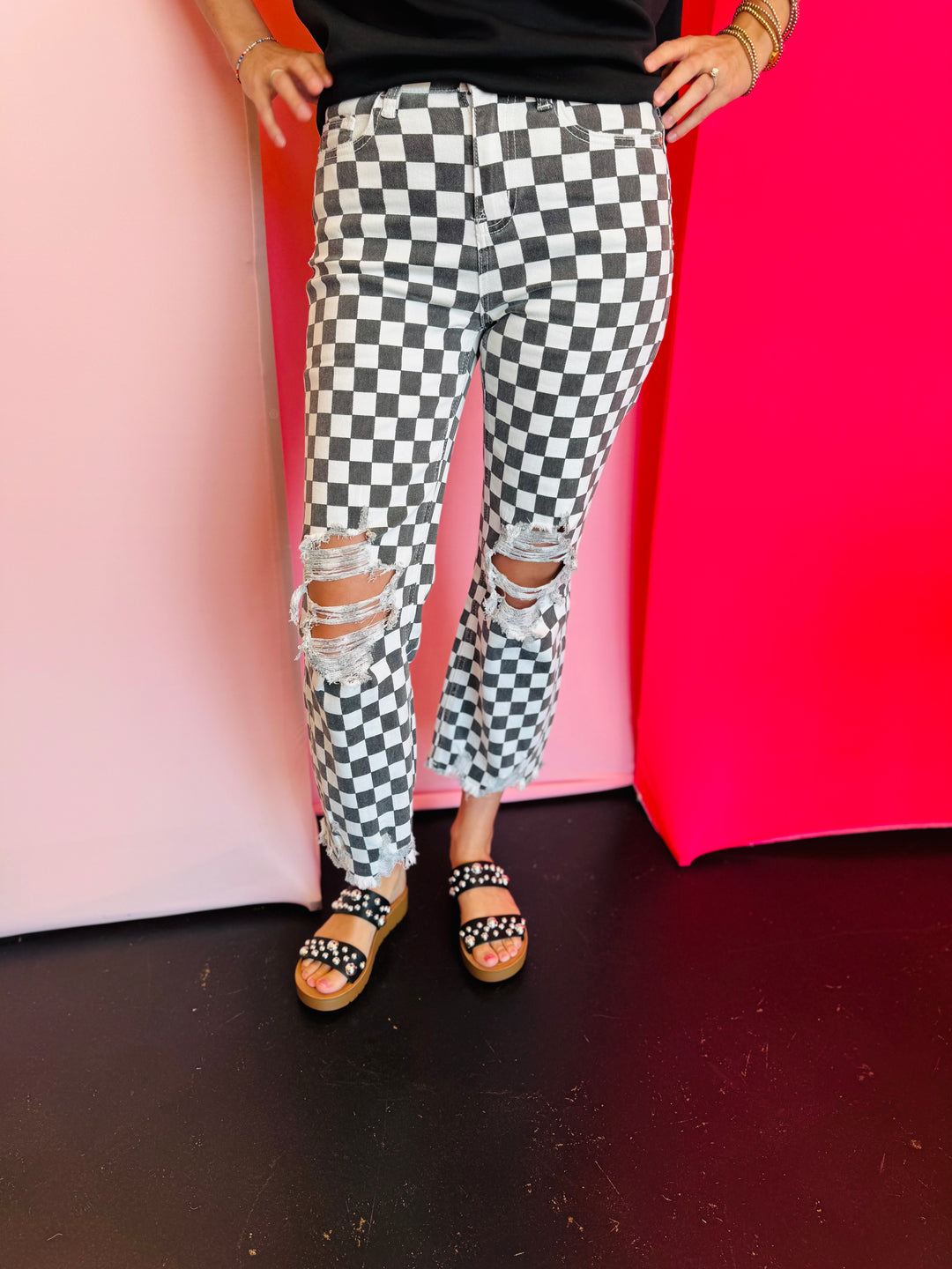 Black and white cropped checkered jeans with knee distressing.