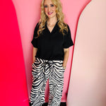 Black and white zebra print wide-leg jogger pants with stretchy fabric and bold safari style.