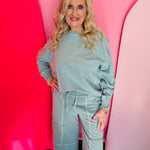 Ash blue French terry long sleeve pullover with contrast stitching and ribbed cuffs.