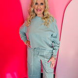 Ash blue French terry long sleeve pullover with contrast stitching and ribbed cuffs.