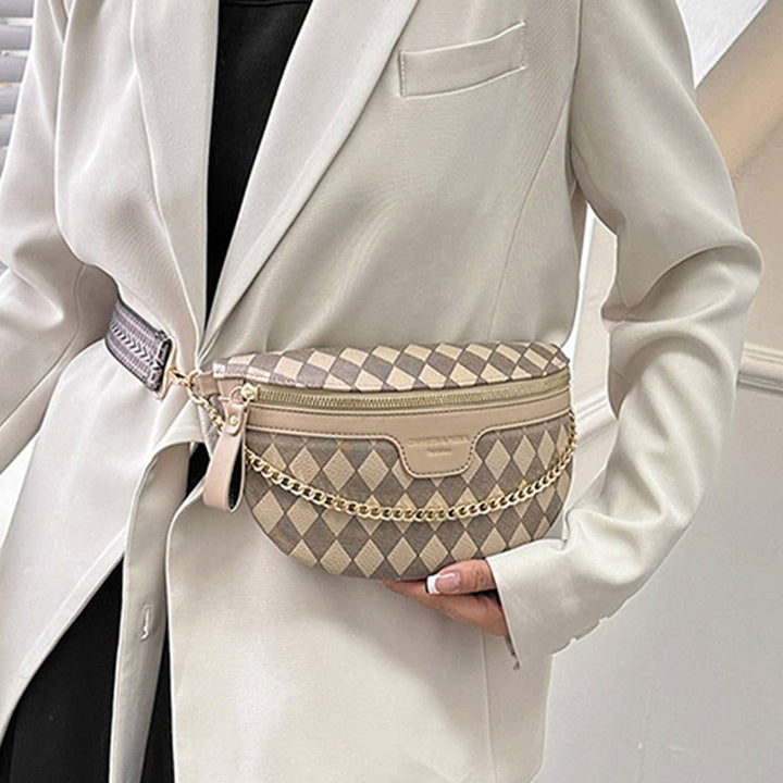 Model showing waist view of  beige checkered fanny pack with gold chain detail.