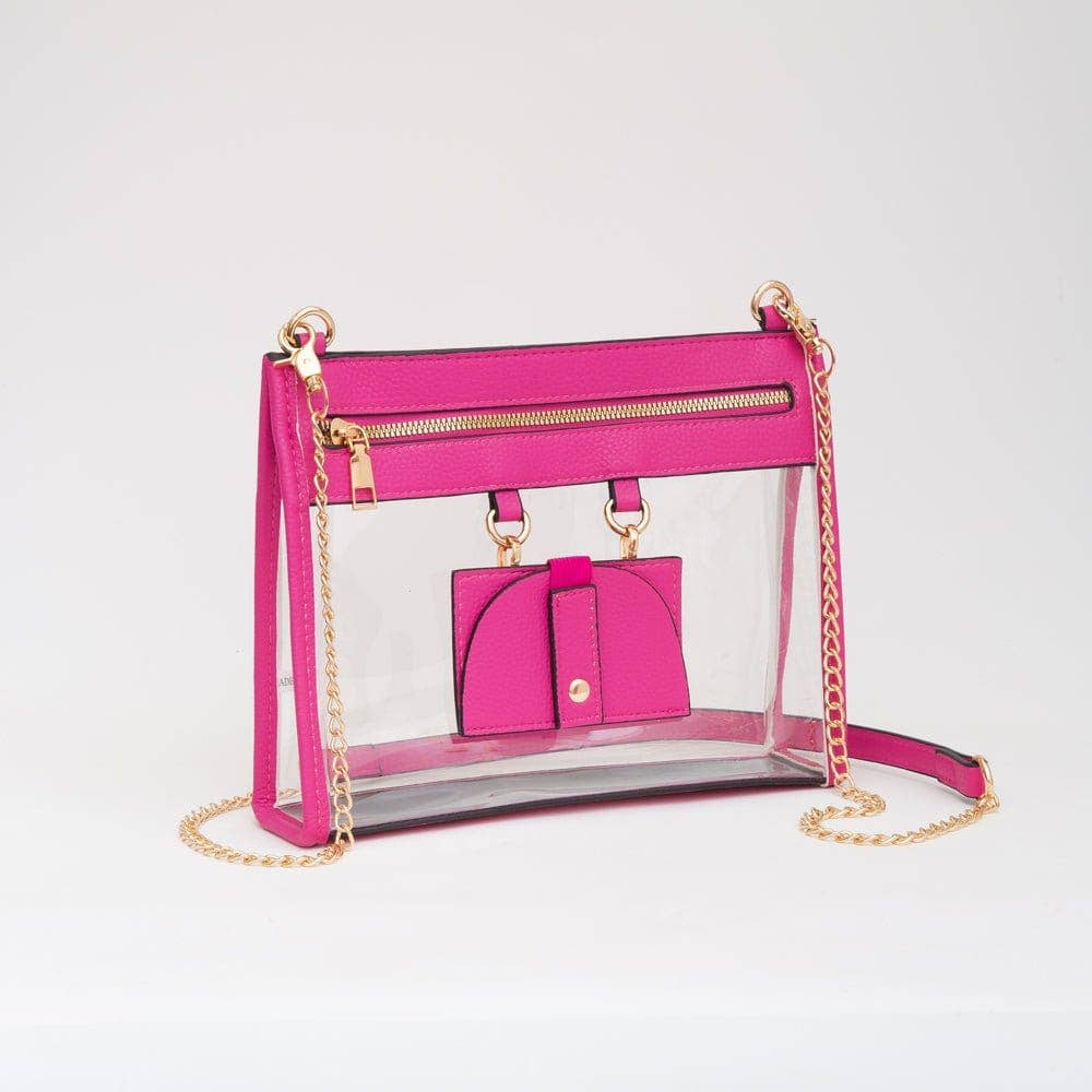 Fuchsia clear crossbody bag with gold hardware and removable sunglasses holder, combining bold style with stadium-friendly function.