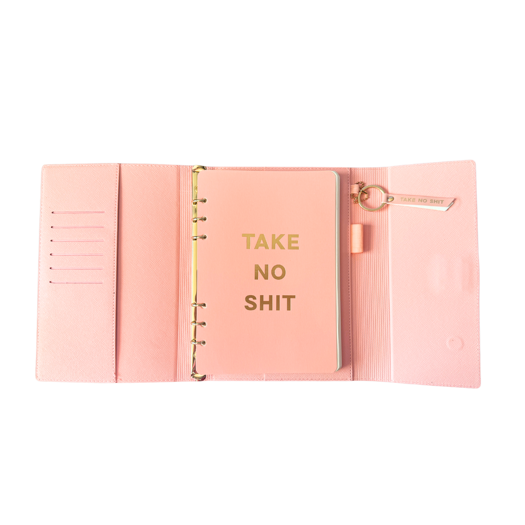 Inside view of pink magnetic closure journal folio and calendar with gold graphics.