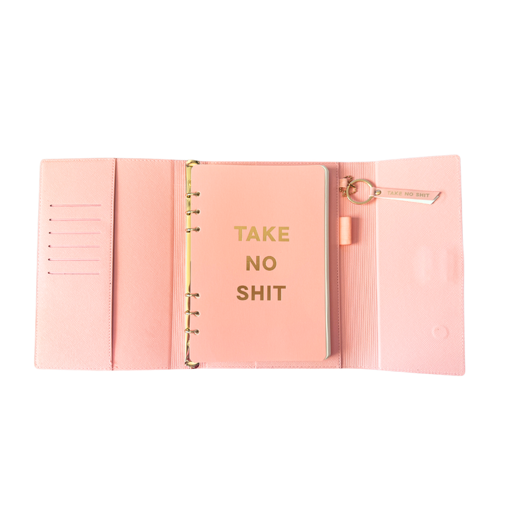 Inside view of pink magnetic closure journal folio and calendar with gold graphics.