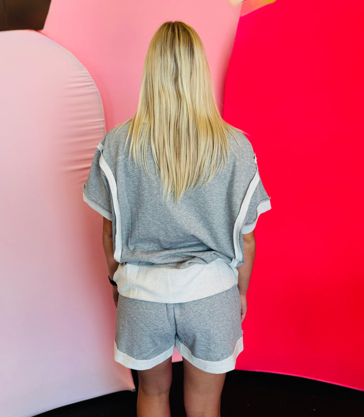Rear view of the set showing the relaxed drape of the top and the fit of the shorts from behind.