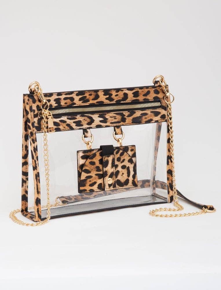 Leopard-trimmed clear crossbody bag with gold hardware and built-in sunglasses holder—stylish, functional, and stadium-ready.