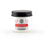 A 6oz glass jar of "Tootsies" therapeutic foot cream, with a small swatch of the cream.