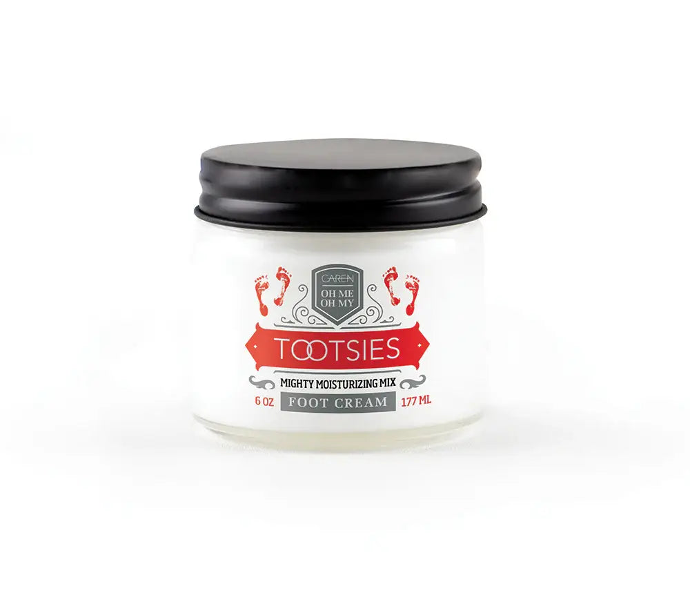 A 6oz glass jar of "Tootsies" therapeutic foot cream, with a small swatch of the cream.