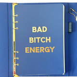 Front page of blue clutch journal folio and calendar with 'BAD BITCH ENERGY' text and colored pen.