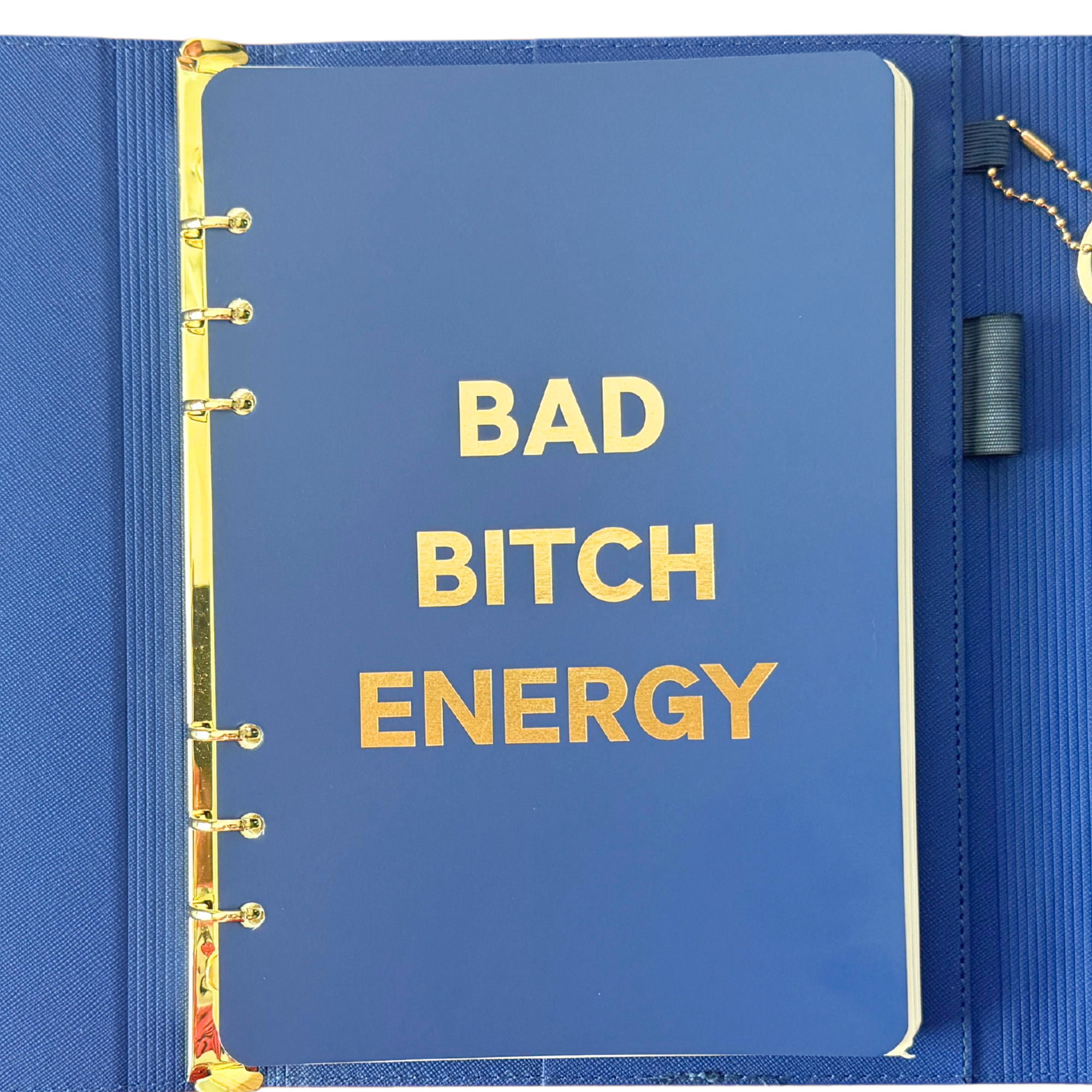 Front page of blue clutch journal folio and calendar with 'BAD BITCH ENERGY' text and colored pen.
