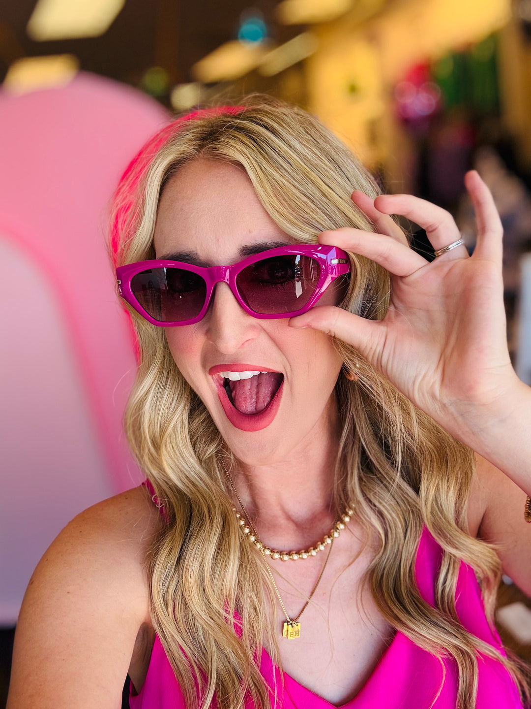 Close-up of the Sawtelle Berry Gradient Sunglasses highlighting the fuchsia-to-black gradient lenses, sharp cat eye edges, and sleek metal detailing.