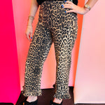 Leopard print ruffled hem pants with high-rise waist and straight-leg silhouette.