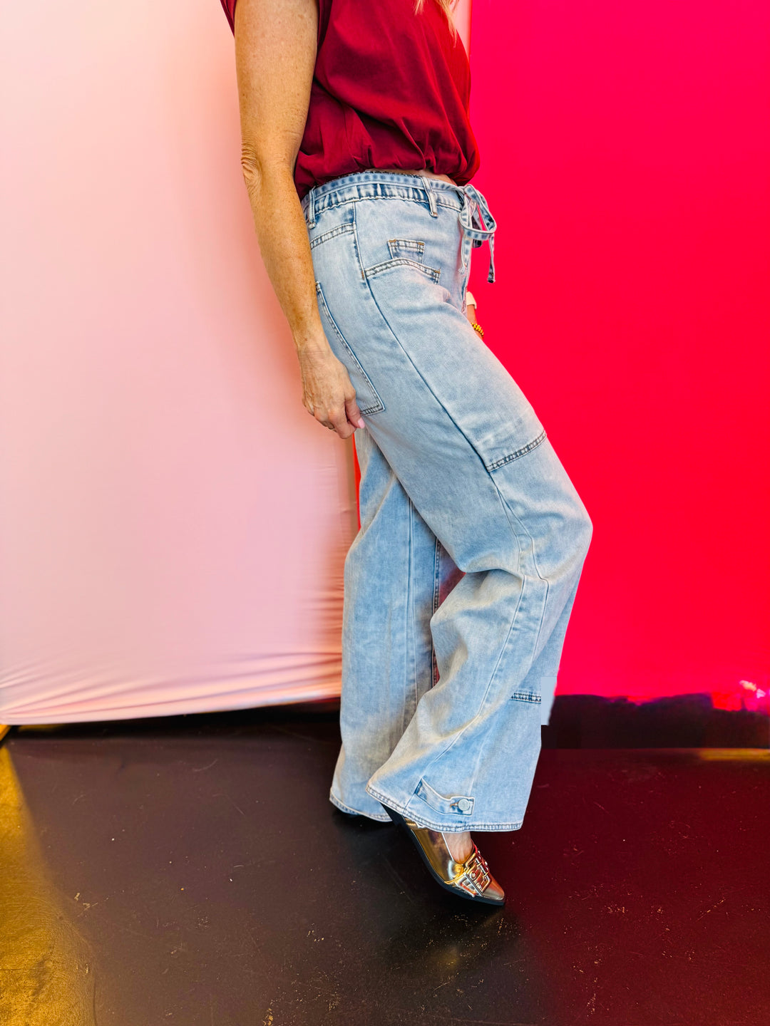 Side profile of the Jovie Tie Waist Jeans showing the adjustable tie waist, side stitching details, and flattering semi high-rise cut.