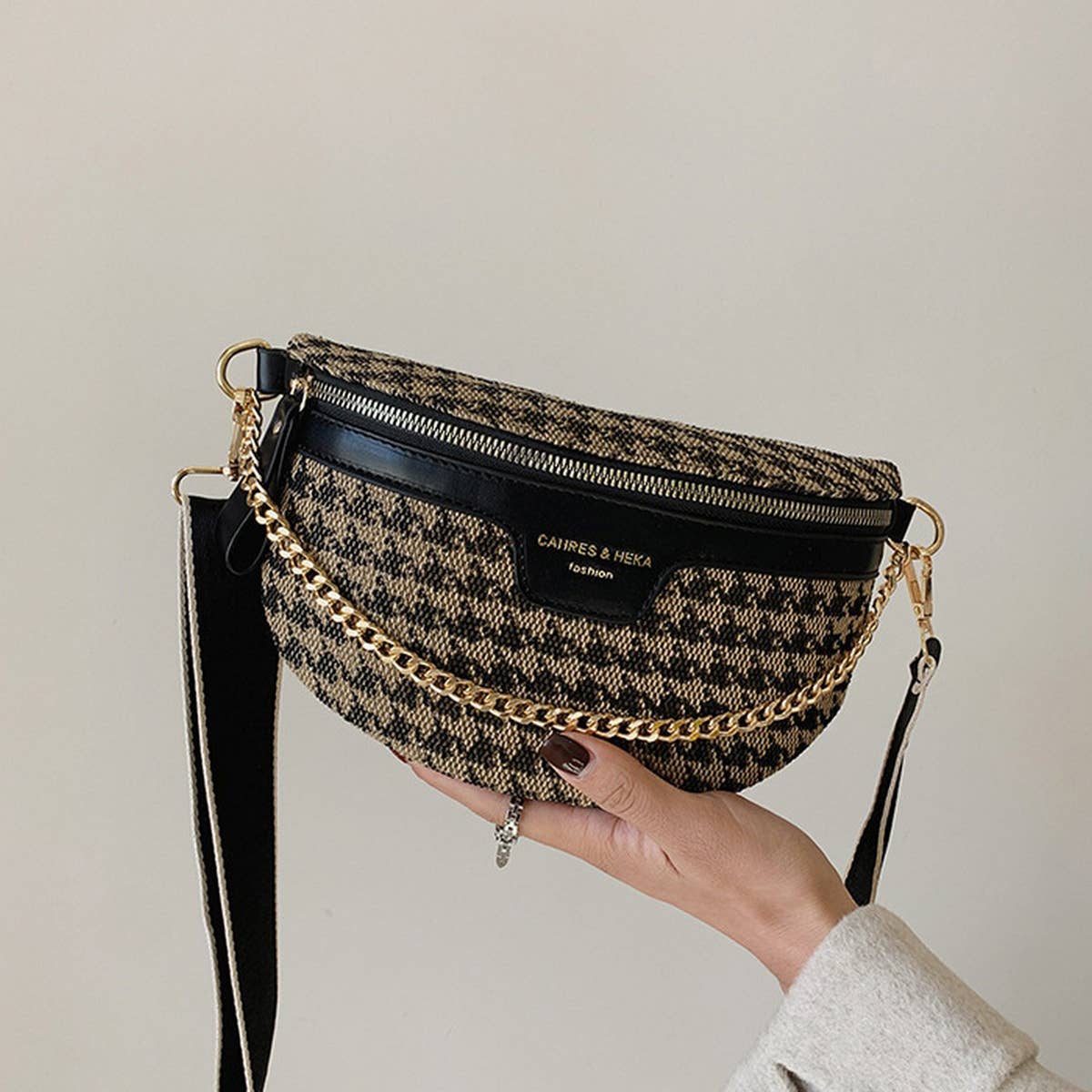Handbag with houndstooth pattern and gold chain strap.