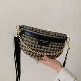Handbag with houndstooth pattern and gold chain strap.