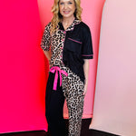 Leopard and black pajama set with pink piping, ruffled pants, and bright pink waist tie.