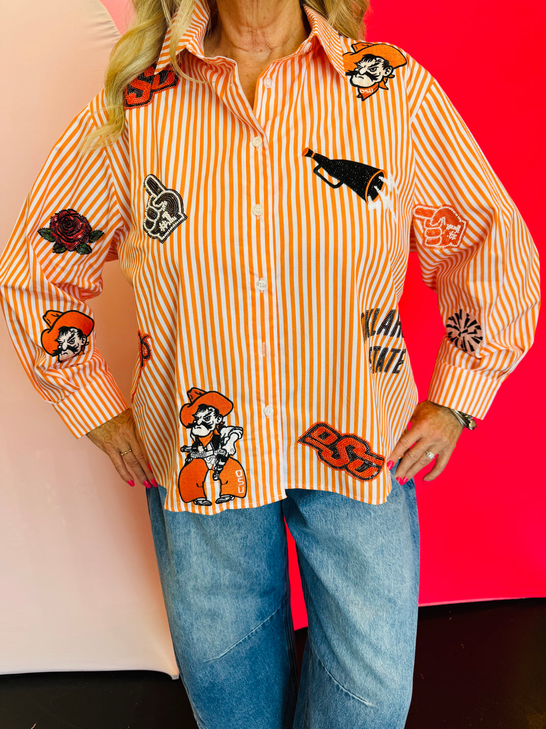 Close up of Queen Of Sparkles orange and white striped icon Oklahoma State University game day blouse.