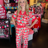 Vibrant pink, red, and mint luxe pajama set with button-up top and elastic-waist pants.