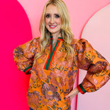 Pumpkin Floral Jacquard Top with puff sleeves, orange floral pattern, and green-red contrast trim.